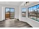 Bright living room featuring hardwood floors, a sliding door, and grid windows showcasing the backyard at 6130 Tara Ave, Las Vegas, NV 89146