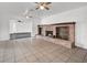 Living room has tile floors, a brick fireplace with built-ins, and is bathed in natural light at 6130 Tara Ave, Las Vegas, NV 89146