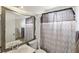 Cozy bathroom featuring a framed mirror, sink, toilet, and patterned shower curtain for added privacy at 6325 Miraloma St, Las Vegas, NV 89108