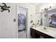 Bathroom featuring a vanity with a sink and a mirror, plus a walk-in closet at 6325 Miraloma St, Las Vegas, NV 89108