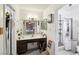 Bathroom with a vanity, large mirror, and a separate shower area at 6325 Miraloma St, Las Vegas, NV 89108