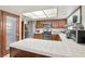 The kitchen has stainless steel appliances, tile countertops, and ample cabinet storage at 6325 Miraloma St, Las Vegas, NV 89108
