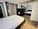 Bedroom features mirrored closet doors, wood-look floors, and neutral decor at 6750 Del Rey Ave # 133, Las Vegas, NV 89146