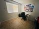 Bright bedroom features a large window, desk, and neutral flooring at 6750 Del Rey Ave # 133, Las Vegas, NV 89146