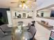 Dining room featuring a modern light fixture, large glass table and 6 chairs at 6750 Del Rey Ave # 133, Las Vegas, NV 89146