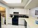 Efficient kitchen layout featuring essential appliances, white cabinets and access to laundry area at 6750 Del Rey Ave # 133, Las Vegas, NV 89146