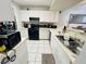 Functional kitchen featuring black appliances, white cabinetry, and light countertops at 6750 Del Rey Ave # 133, Las Vegas, NV 89146