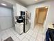 Kitchen area with white cabinets, stainless steel refrigerator, and access to hallway at 6750 Del Rey Ave # 133, Las Vegas, NV 89146