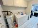 Convenient laundry room with washer, dryer, and overhead cabinets at 6750 Del Rey Ave # 133, Las Vegas, NV 89146