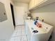 Laundry room features tile floors and modern washer and dryer at 6750 Del Rey Ave # 133, Las Vegas, NV 89146