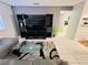 Living room featuring a large television with black stand and grey tile flooring at 6750 Del Rey Ave # 133, Las Vegas, NV 89146