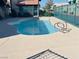 Inviting community pool with a light blue metal fence and access ladder at 6750 Del Rey Ave # 133, Las Vegas, NV 89146