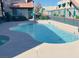 Community swimming pool with a paved surround and a decorative fence at 6750 Del Rey Ave # 133, Las Vegas, NV 89146