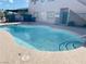 Kidney-shaped community pool surrounded by concrete and metal fencing at 6750 Del Rey Ave # 133, Las Vegas, NV 89146