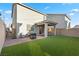 Spacious backyard with patio, artificial grass, and privacy wall; great for entertaining at 6957 Antequera St, Las Vegas, NV 89149
