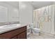 Bright bathroom featuring white fixtures, wood vanity, and a shower and tub at 6957 Antequera St, Las Vegas, NV 89149