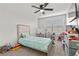 Bright bedroom featuring a ceiling fan, large windows, and carpeted floors at 6957 Antequera St, Las Vegas, NV 89149