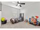 Comfortable bedroom with carpeted floor, ceiling fan, and natural light at 6957 Antequera St, Las Vegas, NV 89149