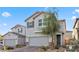 Charming two-story home featuring desert landscaping, a two-car garage, and neutral-toned stucco exterior at 6957 Antequera St, Las Vegas, NV 89149