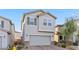 Charming two-story home featuring desert landscaping, a two-car garage, and neutral-toned stucco exterior at 6957 Antequera St, Las Vegas, NV 89149