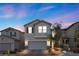 Charming two-story home featuring desert landscaping, a two-car garage, and neutral-toned stucco exterior at 6957 Antequera St, Las Vegas, NV 89149