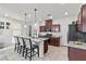 Kitchen featuring a central island with seating, granite countertops, and stainless appliances at 6957 Antequera St, Las Vegas, NV 89149