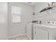 Functional laundry room featuring front load washer and dryer, plus wire shelving at 6957 Antequera St, Las Vegas, NV 89149