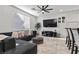Bright living room with modern ceiling fan, large TV, and comfortable seating area with neutral tones at 6957 Antequera St, Las Vegas, NV 89149