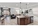 Open floor plan showcasing kitchen island, living room, and access to the backyard at 6957 Antequera St, Las Vegas, NV 89149