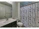 Bright bathroom with a marble-patterned shower curtain, dark vanity, and modern fixtures at 7113 Forest Heights Ct, Las Vegas, NV 89166