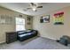Comfortable bedroom features stylish decor, cozy carpet, and a ceiling fan for added comfort at 7113 Forest Heights Ct, Las Vegas, NV 89166
