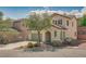 Charming two-story home featuring a tile roof, arched entry, a two-car garage, and desert landscaping at 7113 Forest Heights Ct, Las Vegas, NV 89166