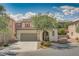 Inviting two-story home with a tile roof, desert landscaping, and an attached two-car garage at 7113 Forest Heights Ct, Las Vegas, NV 89166