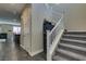 Hallway leading to stairs, featuring neutral tones and access to the dining area at 7113 Forest Heights Ct, Las Vegas, NV 89166