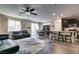 Open-concept living space with a kitchen, dining area, and living room featuring wood-look floors and modern décor at 7113 Forest Heights Ct, Las Vegas, NV 89166