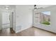 Well-lit bedroom features wood-look flooring and a large window with views of the community at 7200 Pirates Cove Rd # 2089, Las Vegas, NV 89145