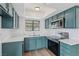 Updated kitchen features attractive blue cabinets, stainless appliances and stunning white counters at 7200 Pirates Cove Rd # 2089, Las Vegas, NV 89145