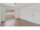 Bright living room features wood-look flooring and a sliding glass door to a balcony at 7200 Pirates Cove Rd # 2089, Las Vegas, NV 89145