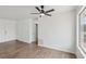 A living room offers neutral colors, wood laminate flooring, and a ceiling fan at 7200 Pirates Cove Rd # 2089, Las Vegas, NV 89145