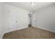 A cozy bedroom with plush carpet, neutral walls, and ample closet space at 728 Carpenter Dr, Las Vegas, NV 89107