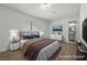 Cozy staged bedroom featuring a large bed and access to an ensuite bathroom at 728 Carpenter Dr, Las Vegas, NV 89107