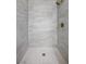 Modern shower with light stone-look tiling and stylish gold fixtures at 728 Carpenter Dr, Las Vegas, NV 89107
