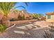 Spacious backyard featuring lush landscaping, brick pavers, and rock ground cover at 7709 Tiny Tortoise St, Las Vegas, NV 89149