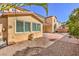 View of the home's back exterior with landscaping of rock and brick at 7709 Tiny Tortoise St, Las Vegas, NV 89149