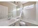 Bright bathroom featuring an extended vanity countertop, a large mirror, and a shower-tub combo at 7709 Tiny Tortoise St, Las Vegas, NV 89149