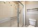 Bathroom featuring glass shower door, decorative fish tiles, and neutral walls at 7709 Tiny Tortoise St, Las Vegas, NV 89149