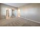 Light filled bedroom offering neutral walls, carpeted flooring, and mirrored closet at 7709 Tiny Tortoise St, Las Vegas, NV 89149