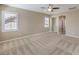 Bright bedroom features plush carpet and modern ceiling fan at 7709 Tiny Tortoise St, Las Vegas, NV 89149