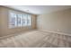 Bedroom featuring neutral carpet, natural lighting, and shuttered window at 7709 Tiny Tortoise St, Las Vegas, NV 89149