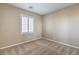 Small bedroom featuring a shuttered window, neutral walls, and carpeted flooring at 7709 Tiny Tortoise St, Las Vegas, NV 89149